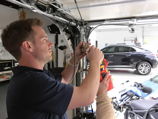 Derby Garage Door Repair safety certified technician performing cable replacement in Derby